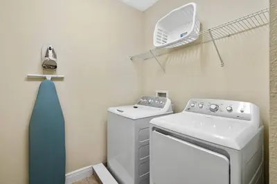 a small laundry room with a washer and dryer at Encore Resort 5 Bedroom Home with Pool 2403 in Orlando