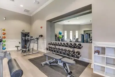 a fitness room with a mirror and a gym at Harry Potter-Themed, Lake View, Spacious Condo Near Universal with Extra Amenities in Orlando