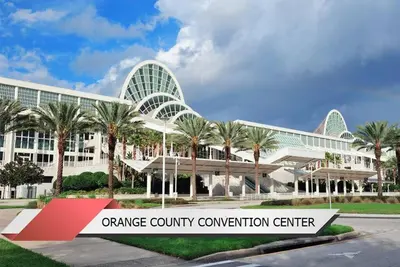 an orange county convention center with palm trees in front of it at Harry Potter-Themed, Lake View, Spacious Condo Near Universal with Extra Amenities in Orlando