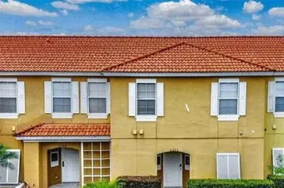 a yellow house with a red roof at Island Abode -near Disney in Kissimmee