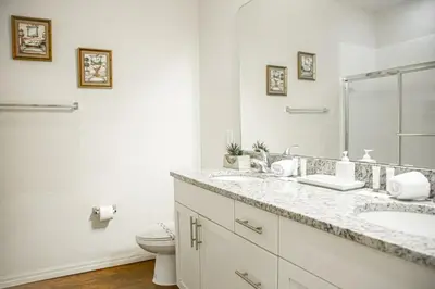 a white bathroom with a sink and a toilet at Charming decorated 3BED at West Lucaya Resort 55 in Kissimmee