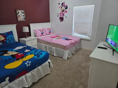 a bedroom with two beds and a desk and a television at Charming decorated 3BED at West Lucaya Resort 55 in Kissimmee
