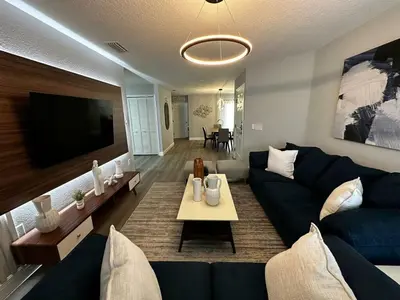 a living room with a blue couch and a tv at Cozy apartment near Disney with 3 bedrooms 58 in Kissimmee