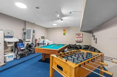 a room with a pool table and a couch at Private Pool Close to Disney Lg Hm Slps 8 in Kissimmee