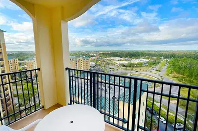 a balcony with a view of a city at Spider-Man-themed condo near Disney, Sea World, Universal and OCCC with pool, spa, restaurants, shuttle, private balcony, and view of fireworks shows in Orlando