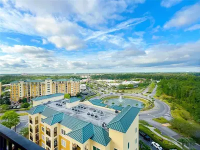 an aerial view of a resort with a pool and buildings at Spider-Man-themed condo near Disney, Sea World, Universal and OCCC with pool, spa, restaurants, shuttle, private balcony, and view of fireworks shows in Orlando
