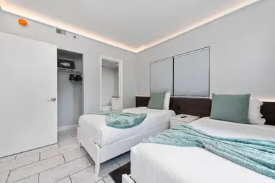 a bedroom with two beds and a couch at 2 suites ground floor apartment near Intern Drive in Orlando