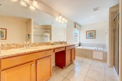 a large bathroom with a sink and a tub at Spacious 6BR family villa, 10 min to Disney, private pool, resort waterpark in Kissimmee