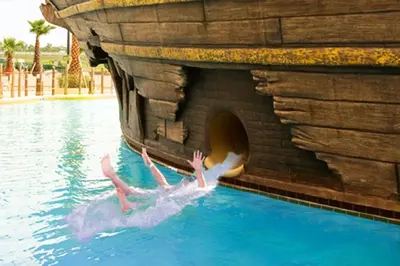 a person in the water in a water slide at Lion King-themed condo near Disney, Sea World, Universal and OCCC with pool, spa, restaurants, shuttle, private balcony, and the BEST view of fireworks shows in Orlando