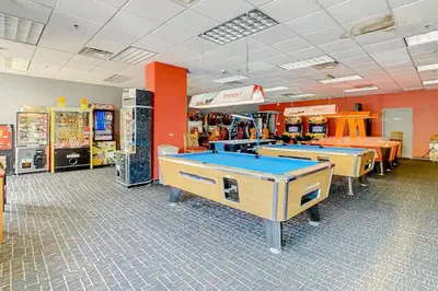 a store with two ping pong tables in a room at Lion King-themed condo near Disney, Sea World, Universal and OCCC with pool, spa, restaurants, shuttle, private balcony, and the BEST view of fireworks shows in Orlando