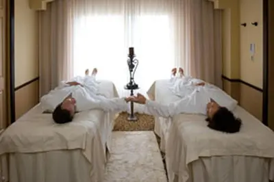 two people laying in beds in a hospital room at Lion King-themed condo near Disney, Sea World, Universal and OCCC with pool, spa, restaurants, shuttle, private balcony, and the BEST view of fireworks shows in Orlando