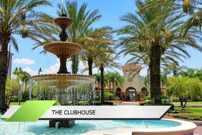 a fountain in front of a building with palm trees at Marvel-Themed, Spacious Condo Near OCCC, Sea World, Disney, and Universal with Extra Amenities in Orlando