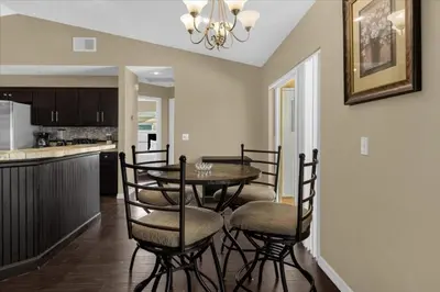 a dining room and kitchen with a table and chairs at 5Bd 2 Bath with Gameroom & Pool 1 story House in Orlando