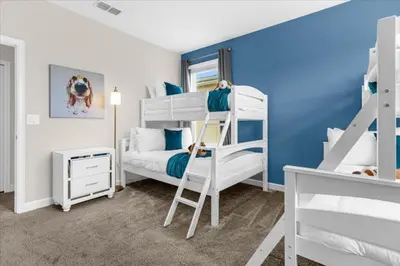 a bedroom with two bunk beds and a bed at 5 Bedrroms 5 Bathrooms Storey Lake 2739 Bd in Kissimmee
