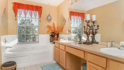 a bathroom with a tub and a sink and a tub and a bath tub at The Skywalker in Orlando