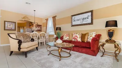 a living room with a red couch and a table at The Skywalker in Orlando
