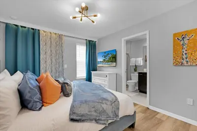a bedroom with a bed and a ceiling fan at Villa Grande in Orlando