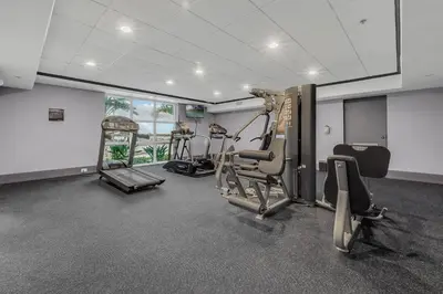 a gym with several tread machines in a room at K and J Orlando in Orlando