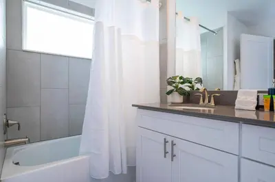 a bathroom with a sink and a tub and a shower at Luxury Stay Near Disney Storey Lake Resort 2568 in Kissimmee