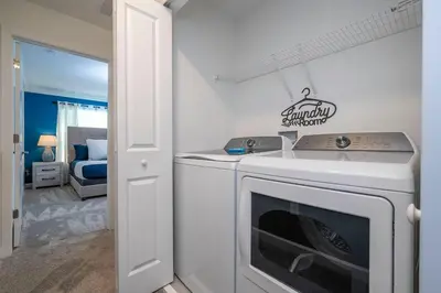 a kitchen with a washing machine in a room at Luxury Stay Near Disney Storey Lake Resort 2568 in Kissimmee