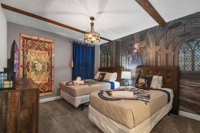 a bedroom with two beds and a painting on the wall at Lake View Cozy Home w/ Pool & Games Near Disney in Kissimmee