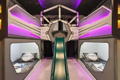a kids room with a slide and two beds at Luxury 12BR Villa w/ Pool & Spa Near Disney in Kissimmee