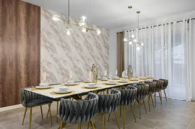 a dining room with a long table and chairs at Luxury 12BR Villa w/ Pool & Spa Near Disney in Kissimmee