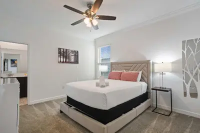 a bedroom with a bed with a ceiling fan at Luxurious Resort Home Near Disney & Shopping! in Kissimmee