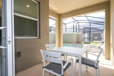 a dining room with a white table and chairs at Fantastic Mickey house Waterpark near Disney 2572 in Kissimmee