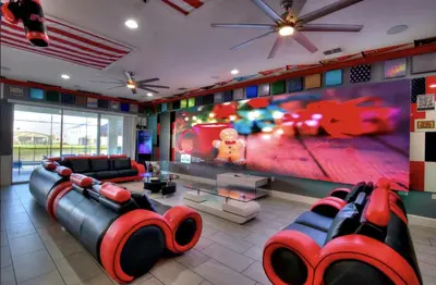 a living room with a large flat screen tv at All Vacation Mansion w Spa-Pool-Cinema Sleep 40 in Kissimmee