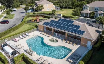 an aerial view of a house with a swimming pool with solar panels at Comfortable home Near Disney & Private Pool 17414 in Orlando