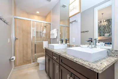 a bathroom with two sinks and a shower at Stunning Villa 5 min to Disney in Orlando