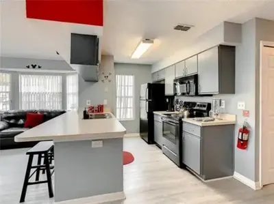 a kitchen with a stove and a counter top at Disney Themed Condo in Kissimmee