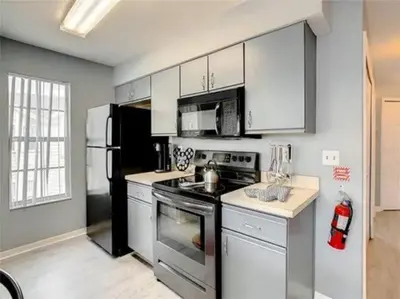 a kitchen with a stove and a refrigerator at Disney Themed Condo in Kissimmee