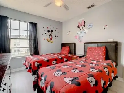 a bedroom with two beds with hello kitty comforters at Disney Themed Condo in Kissimmee