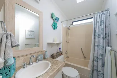 a bathroom with a sink and a toilet and a shower at Disney Backyard Oasis in Orlando
