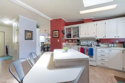 a kitchen with white cabinets and a table and chairs at Disney Backyard Oasis in Orlando