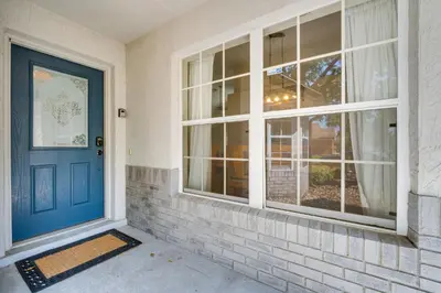 a blue door on a house with a window at 11 Mi to WDW Kissimmee House with Private Pool! in Kissimmee