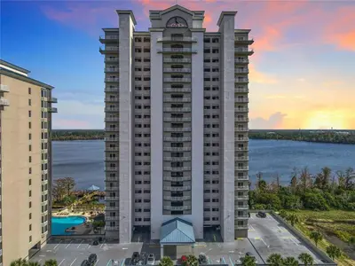 an aerial view of a large apartment building with a lake at Sunshine Oasis - Orlando Lakefront Luxury in Orlando