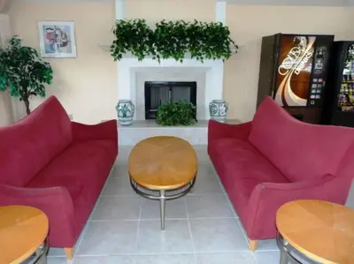 a living room with two red couches and a fireplace at HARRY POTTER LIVES HERE! Unforgettable Home, Pool, Sleeps 8, Near Dis, LOW Rates! in Kissimmee