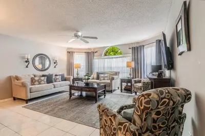 a living room with a couch and a table at HARRY POTTER LIVES HERE! Unforgettable Home, Pool, Sleeps 8, Near Dis, LOW Rates! in Kissimmee