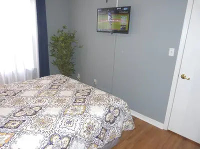 a bedroom with a bed and a tv on the wall at FABULOUS New Decor, Near Dis, Fireplace, Star Wars Children's BR, Next To Pool, LOW rates! in Kissimmee