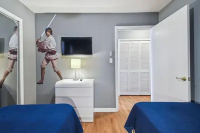 a room with two beds and a man with a sword at FABULOUS New Decor, Near Dis, Fireplace, Star Wars Children's BR, Next To Pool, LOW rates! in Kissimmee