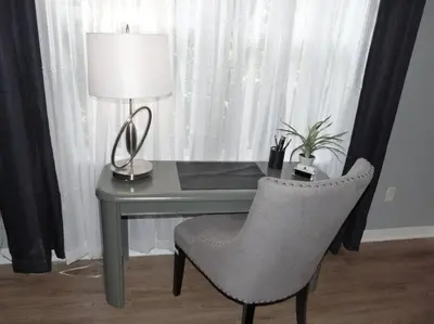 a desk with a chair and a table with a lamp at FABULOUS New Decor, Near Dis, Fireplace, Star Wars Children's BR, Next To Pool, LOW rates! in Kissimmee