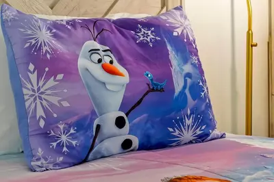 a pillow with a snowman and a bird on a bed at Spacious Condo W/ Pool,Gym near Disney & Seaworld in Kissimmee