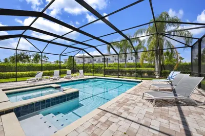 an indoor swimming pool with a glassconservatory with chairs and a swimming poolvisor at Spacious Home With Private Pool Near Disney With Waterpark & Resort Access At Encore Resort - 7720Ff in Kissimmee