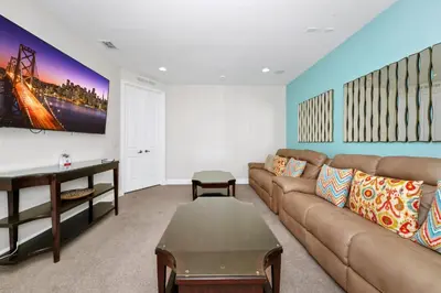a living room with a couch and a table at Spacious Home With Private Pool Near Disney With Waterpark & Resort Access At Encore Resort - 7720Ff in Kissimmee
