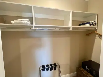 a shelf in a kitchen with white cabinets at Luxury Home in Orlando with private Hot Tub - 7 Min from Disney Parks - 3 bedrooms and 4 bathrooms! in Orlando
