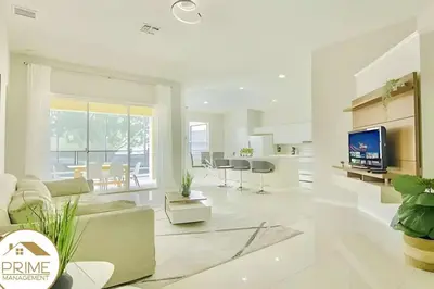 a living room with a couch and a tv at Renewed & Cozy 4BD Great Location near Disney in Kissimmee