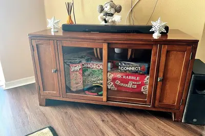 a wooden cabinet with a television on top of it at Disney Villa Magical Retreat Private Pool, LakeView & Game Room in Kissimmee